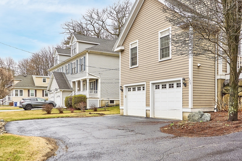 820 Main Street, Unit 1 Wakefield, MA 01880 - Photo 7 of 36 a front view of a house with a yard