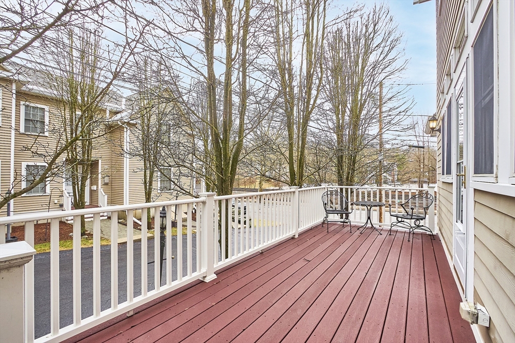 820 Main Street, Unit 1 Wakefield, MA 01880 - Photo 8 of 36 a view of balcony with wooden floor and fence