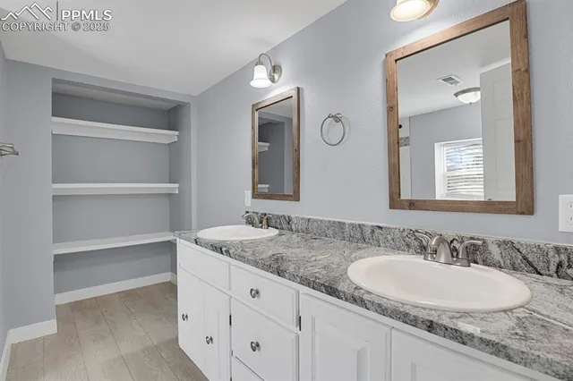 a bathroom with a sink double vanity and a mirror