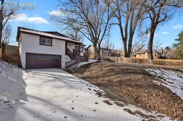 a view of a house with a yard covered with snow