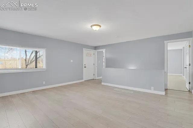 a view of an empty room with a window