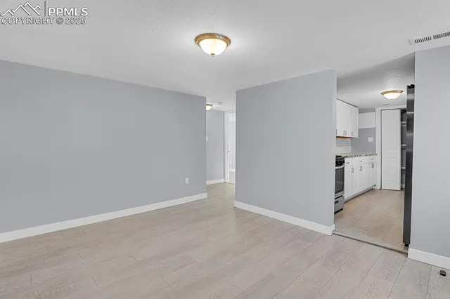 a view of a kitchen with a sink and a refrigerator