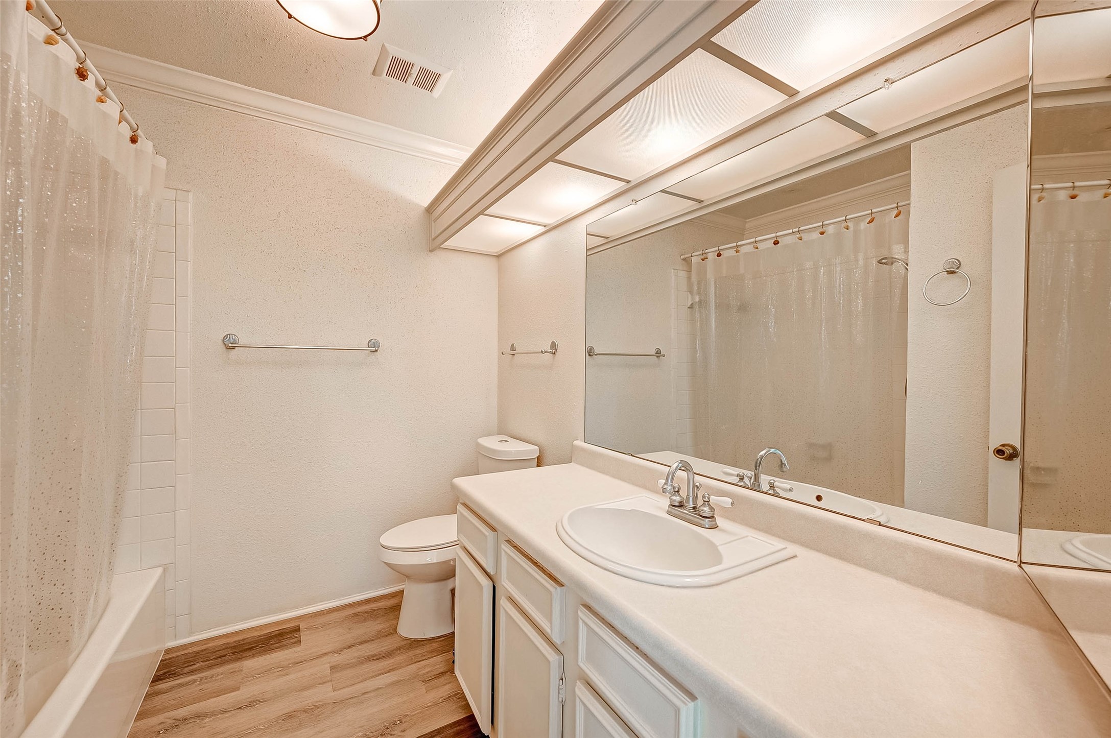 1908 Augusta Drive, Unit 7 Houston, TX 77057 - Photo 28 of 33 a bathroom with a sink a toilet a shower and a mirror