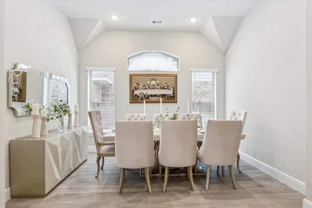 a view of a dining room with furniture and a large window