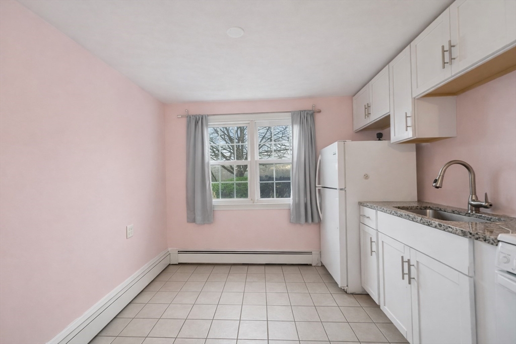 180 Tyngsboro Road, Unit 17A Chelmsford, MA 01863 - Photo 2 of 10 a view of a kitchen with a sink and dishwasher and a window
