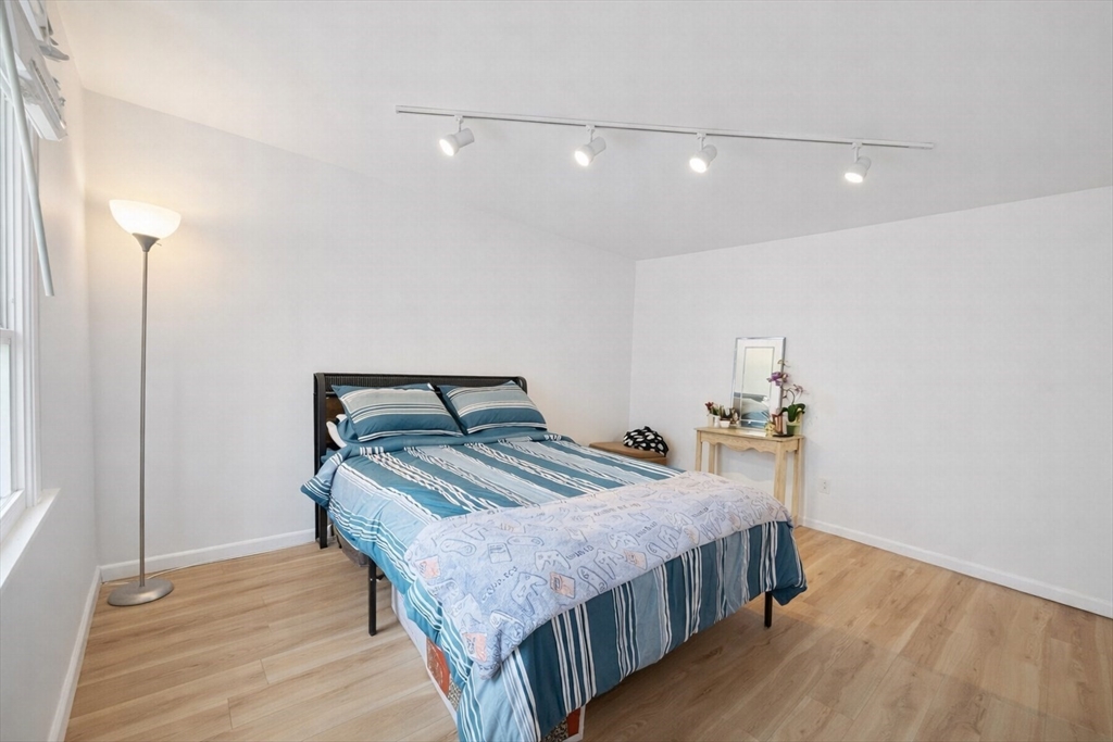 180 Tyngsboro Road, Unit 17A Chelmsford, MA 01863 - Photo 6 of 10 a bedroom with double bed and a wooden floor