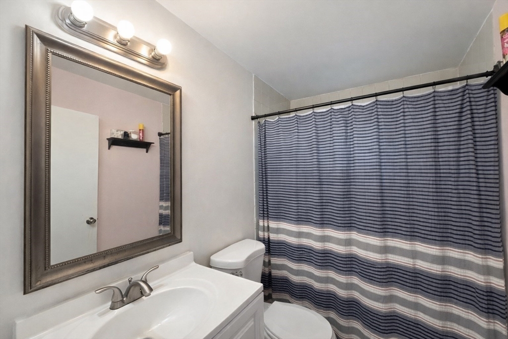 180 Tyngsboro Road, Unit 17A Chelmsford, MA 01863 - Photo 8 of 10 a bathroom with a sink a toilet and shower