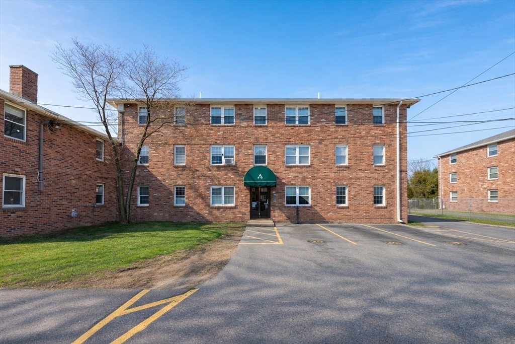 180 Tyngsboro Road, Unit 17A Chelmsford, MA 01863 - Photo 10 of 10 a front view of a building with a garden and plants