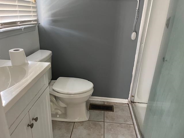 230 James Road Bolivar, TN 38008 - Photo 12 of 14 Bathroom with vanity, toilet, tile patterned floors, and a shower with door