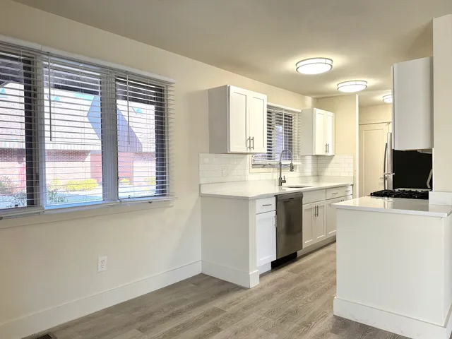 a kitchen with a stove a sink and a microwave