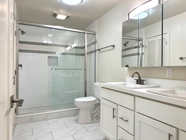 a bathroom with a sink toilet and shower