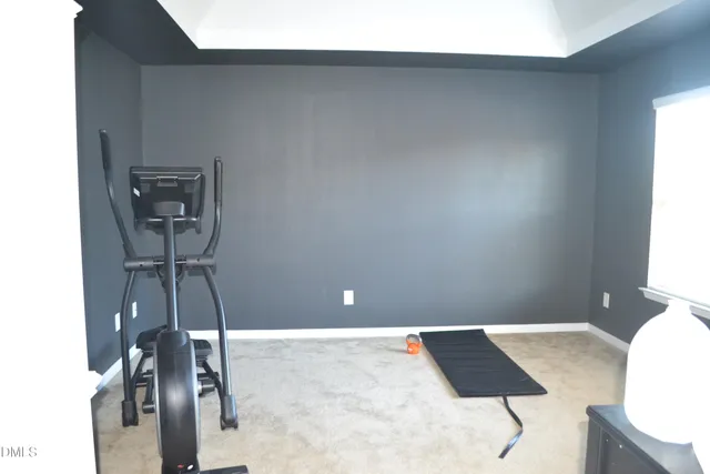 a living room with a bed and a dresser