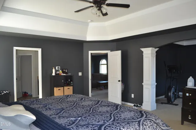 a living room with furniture a fireplace and a chandelier