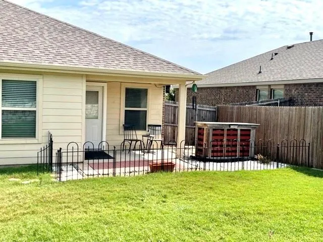 a front view of house with a garden