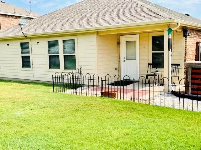 a view of a house with a backyard and porch