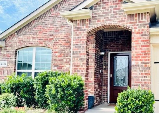 a front view of a house with plants