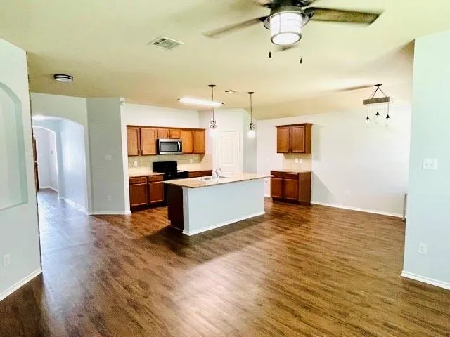 a large kitchen with cabinets and stainless steel appliances