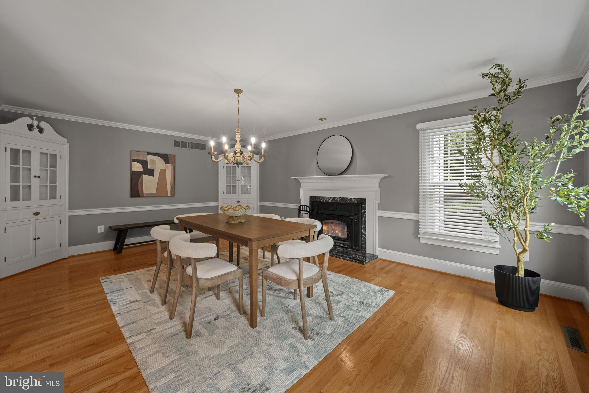3484 Olympia Road Davidsonville, MD 21035 - Photo 6 of 50 a dining room with wooden floor a chandelier a wooden table and chairs