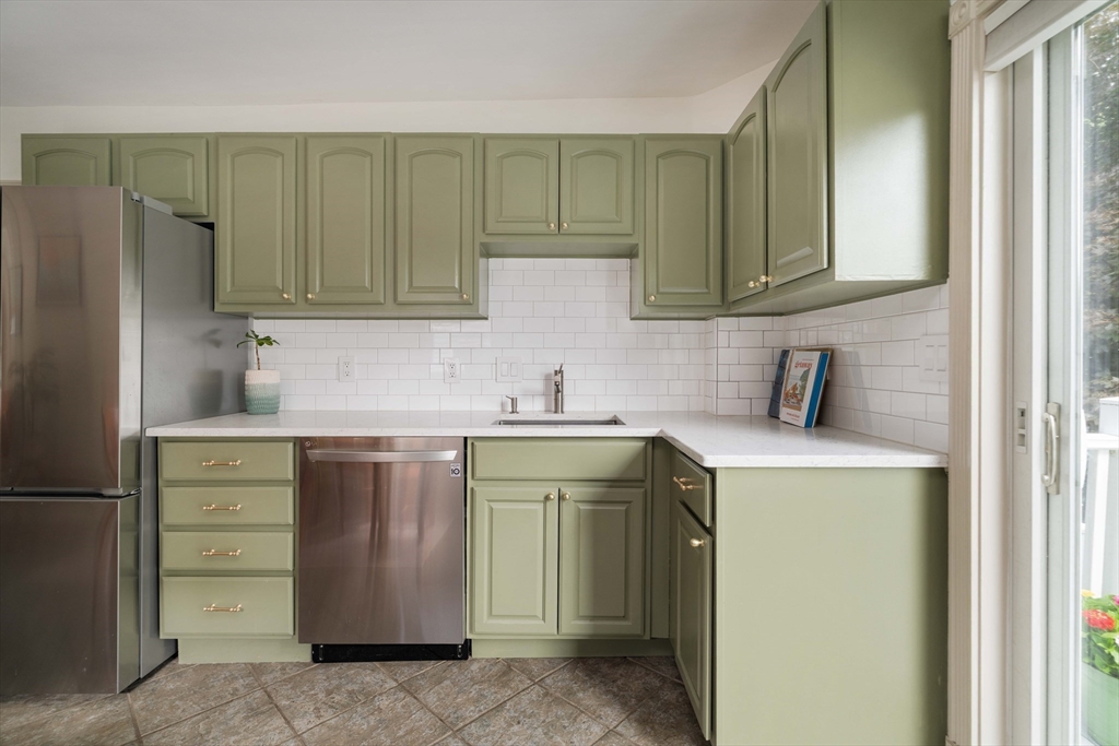 52 Victoria Street, Unit B Somerville, MA 02144 - Photo 11 of 32 a kitchen with a sink and a refrigerator