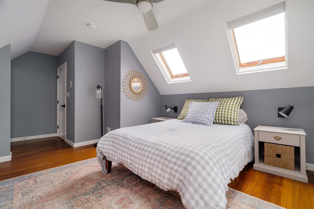 52 Victoria Street, Unit B Somerville, MA 02144 - Photo 24 of 32 a bedroom with a bed and a chandelier