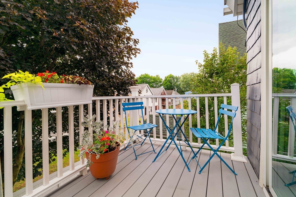52 Victoria Street, Unit B Somerville, MA 02144 - Photo 31 of 32 a view of balcony with chairs and wooden floor