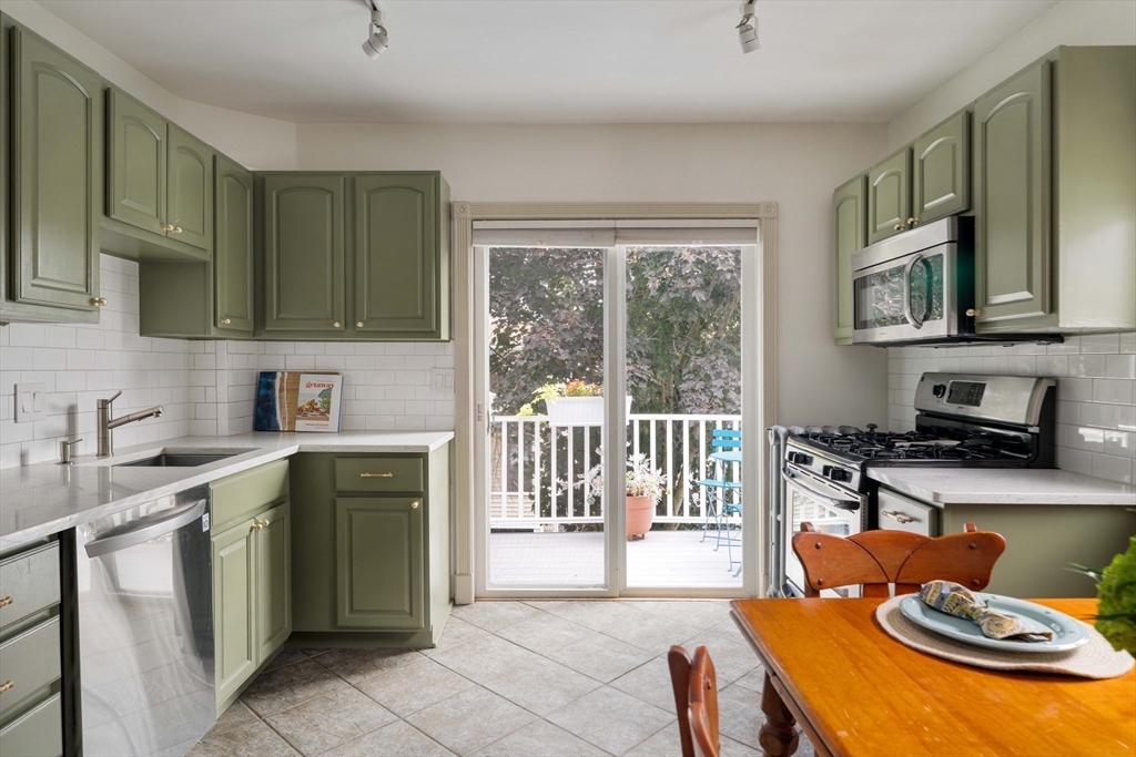 52 Victoria Street, Unit B Somerville, MA 02144 - Photo 8 of 32 a kitchen with a stove a sink and a microwave