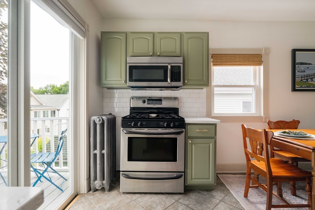 52 Victoria Street, Unit B Somerville, MA 02144 - Photo 10 of 32 a kitchen with stainless steel appliances a stove a sink and a microwave