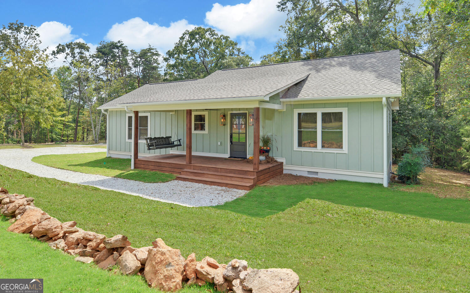 a view of a house with a yard and porch