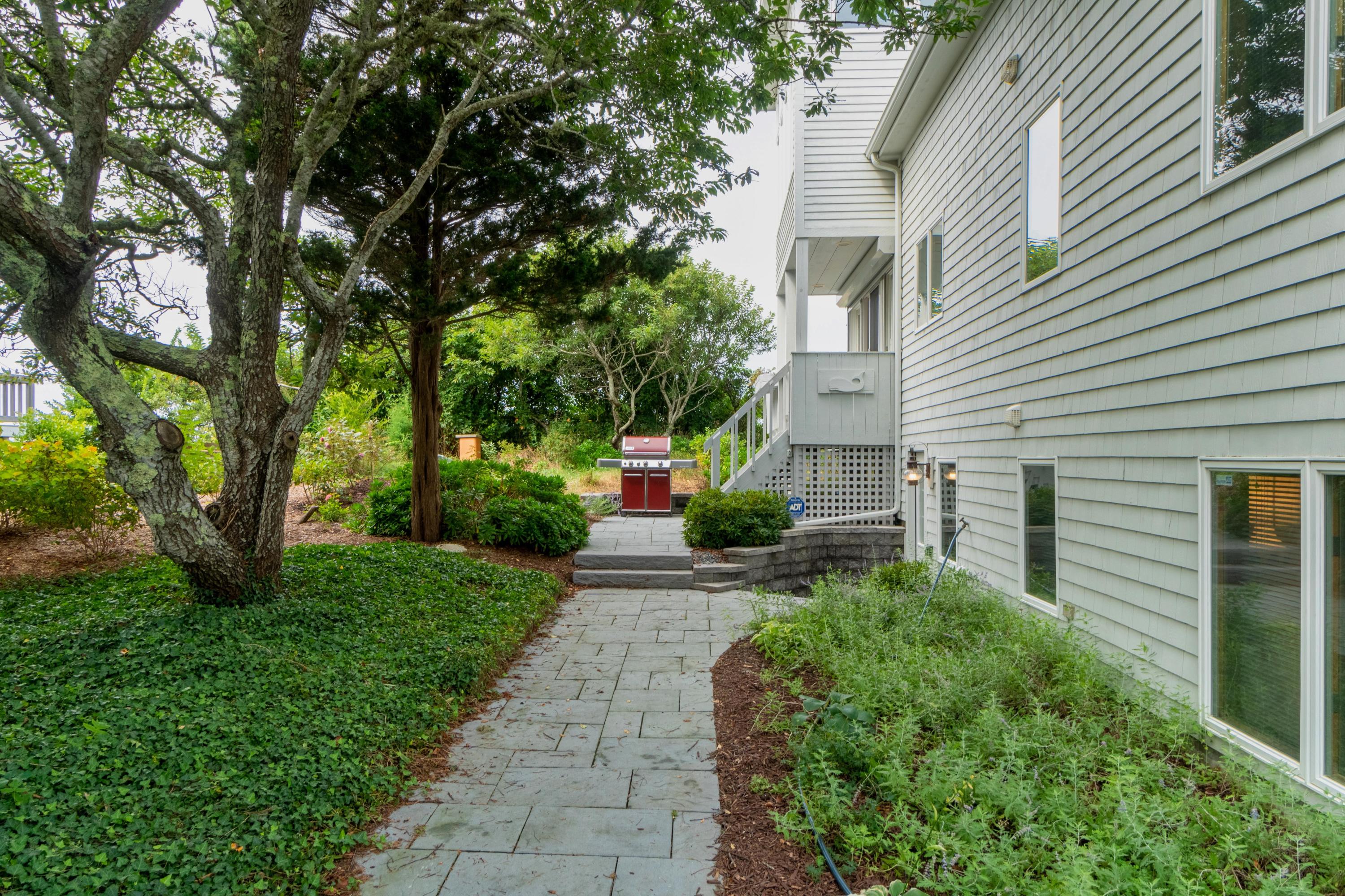29 Bayberry Lane Eastham, MA 02642 - Photo 13 of 35 a front view of a house with a yard and a tree