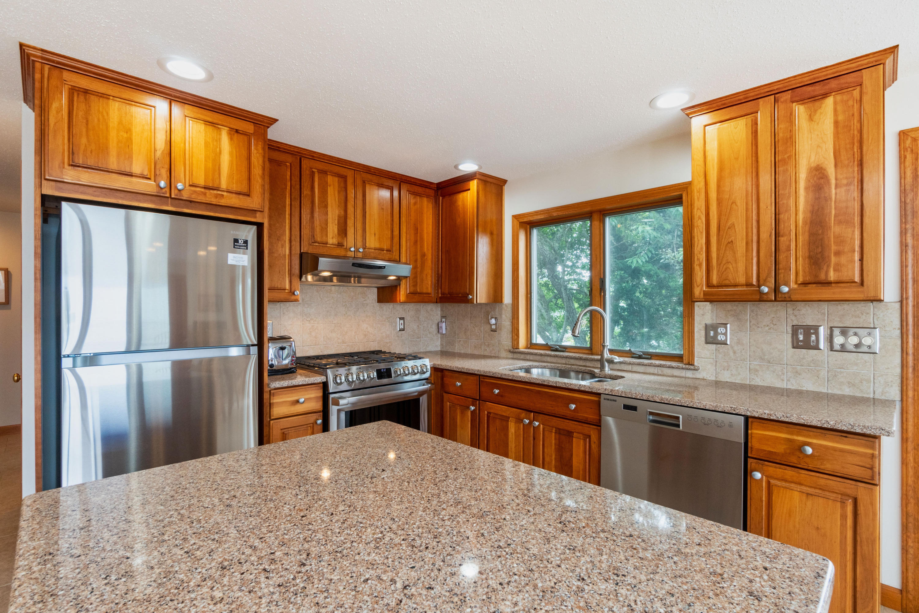 29 Bayberry Lane Eastham, MA 02642 - Photo 17 of 35 a kitchen with stainless steel appliances granite countertop a refrigerator sink stove microwave and cabinets