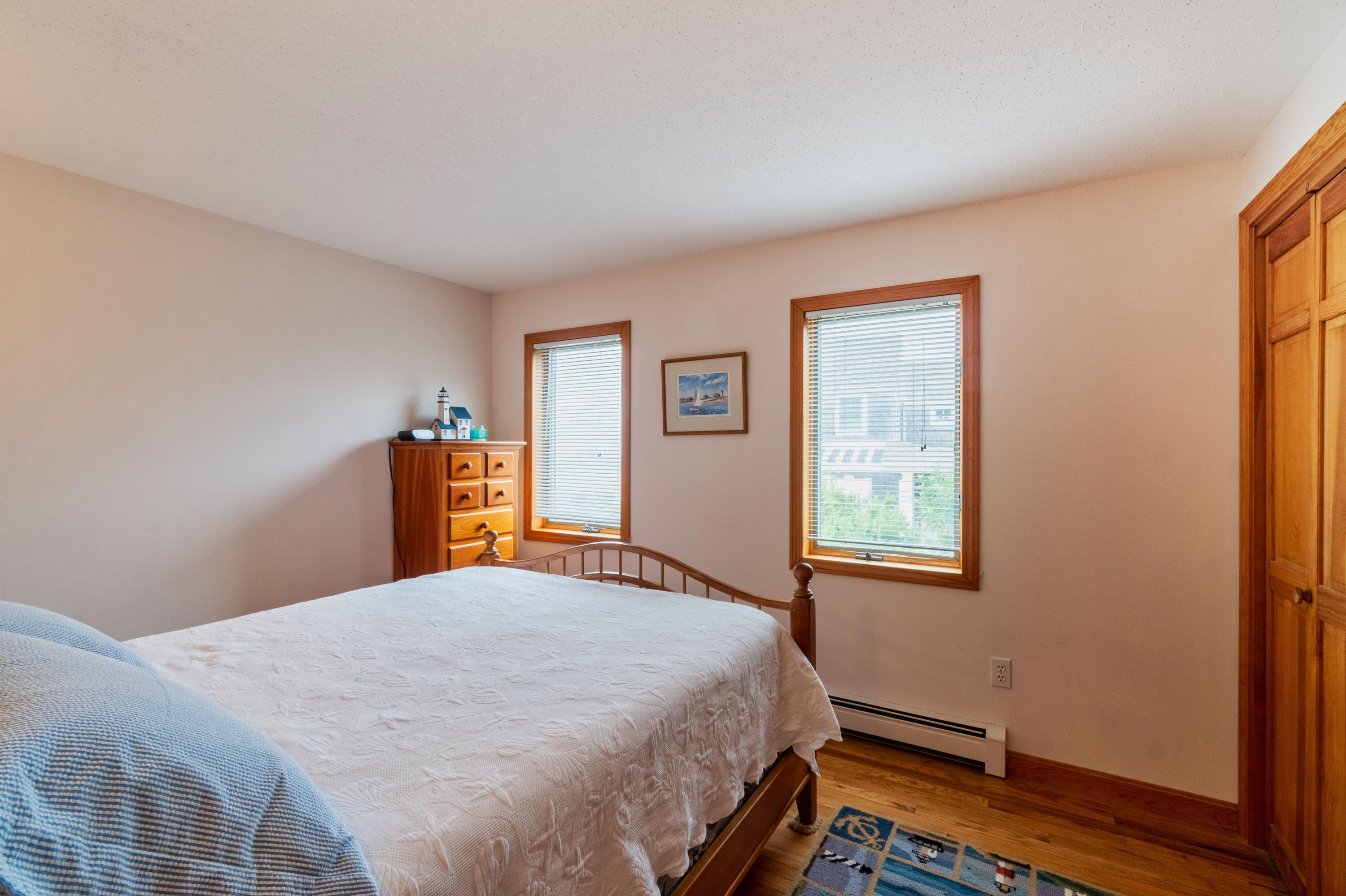 29 Bayberry Lane Eastham, MA 02642 - Photo 23 of 35 a bedroom with a bed and wooden floor