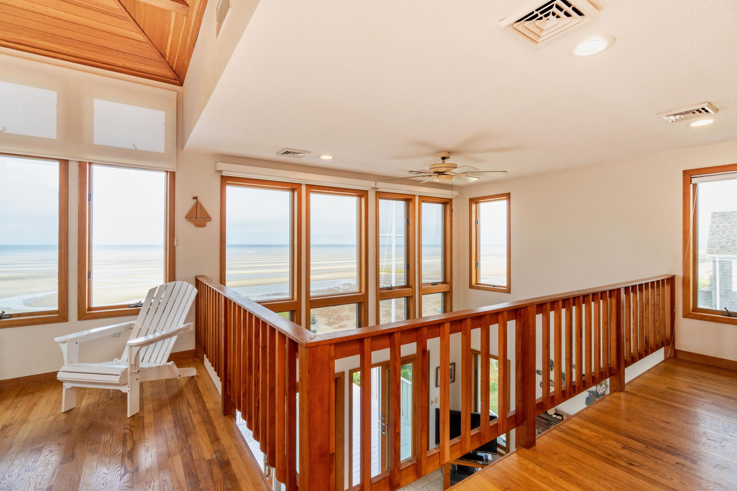 29 Bayberry Lane Eastham, MA 02642 - Photo 26 of 35 a view of hallway with wooden floor and staircase