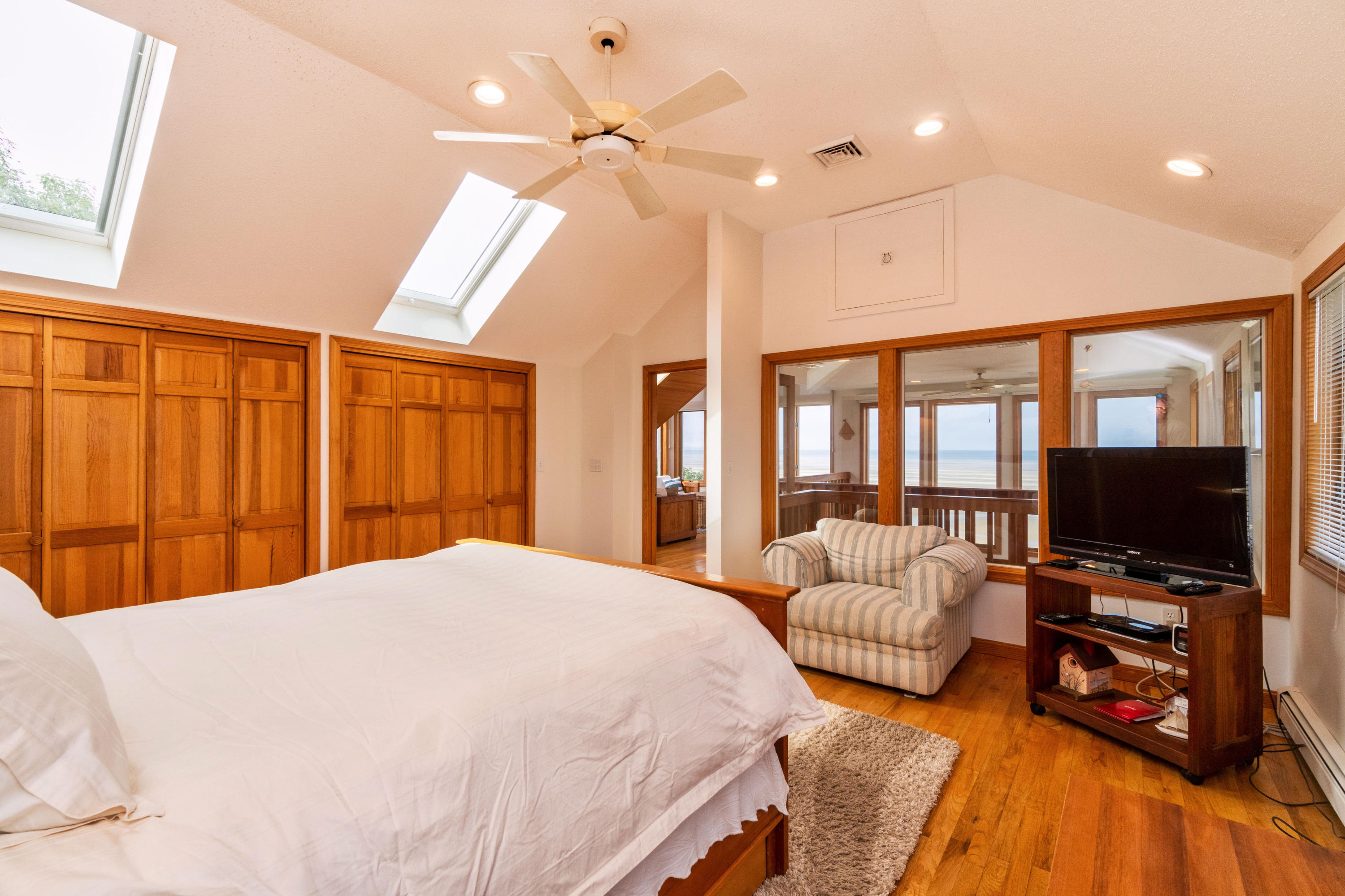 29 Bayberry Lane Eastham, MA 02642 - Photo 29 of 35 a bedroom with a bed television and a large window