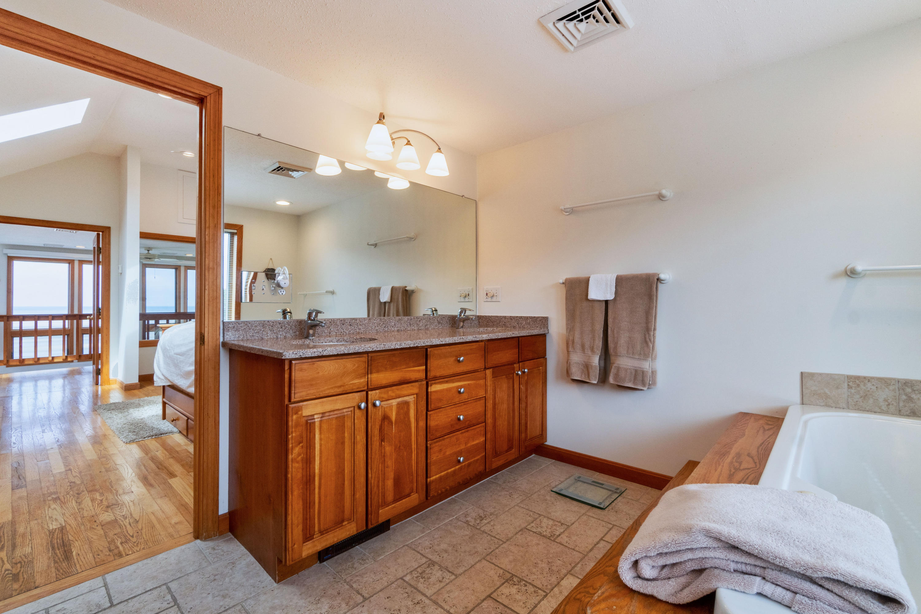 29 Bayberry Lane Eastham, MA 02642 - Photo 31 of 35 a spacious bathroom with a granite countertop double vanity sink and a mirror
