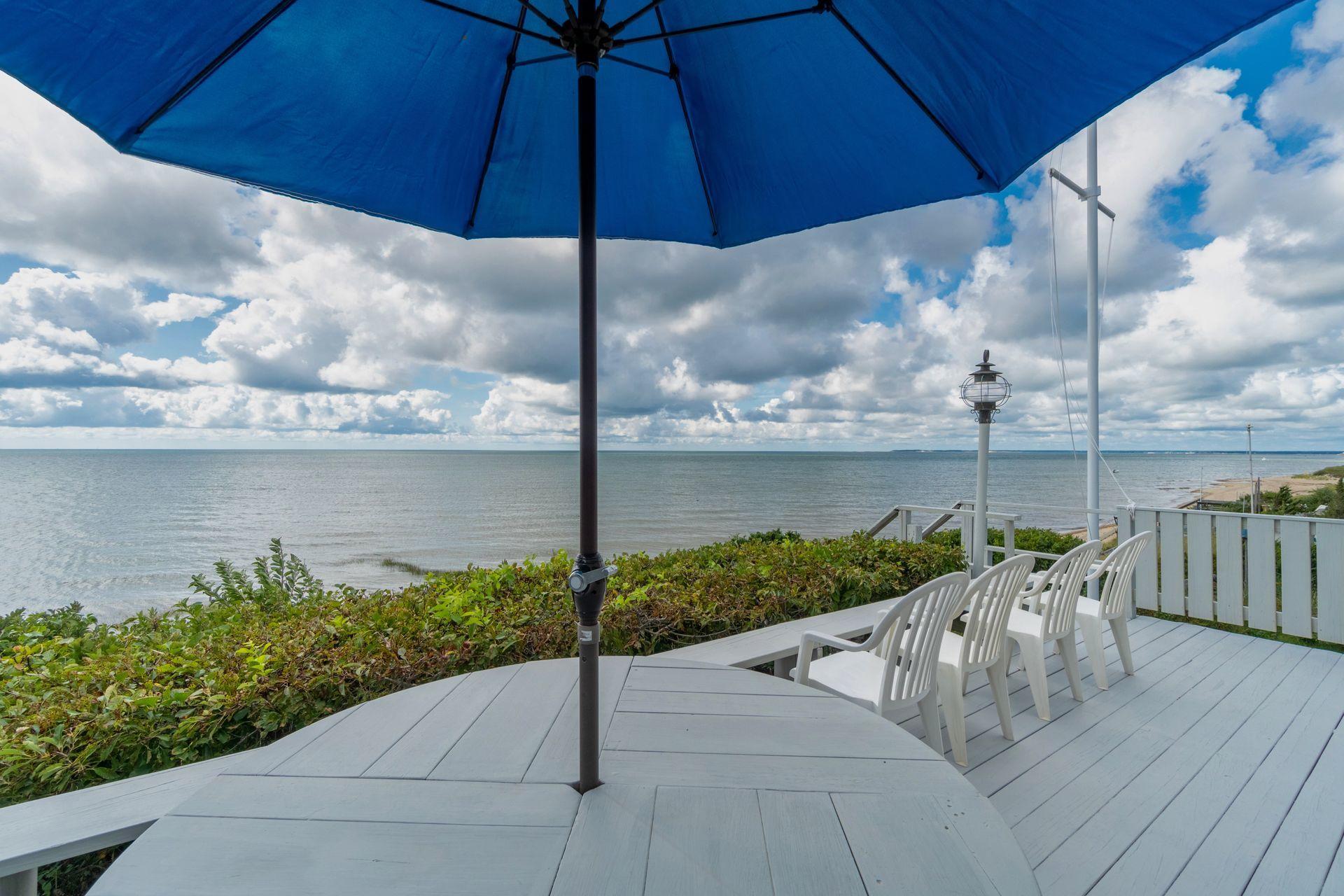 29 Bayberry Lane Eastham, MA 02642 - Photo 35 of 35 a view of a patio with a table and chairs under an umbrella