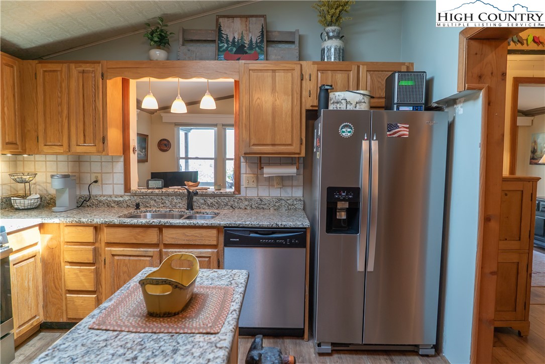 10 Locust Road Newland, NC 28657 - Photo 11 of 36 a kitchen with stainless steel appliances granite countertop a refrigerator a stove and a sink