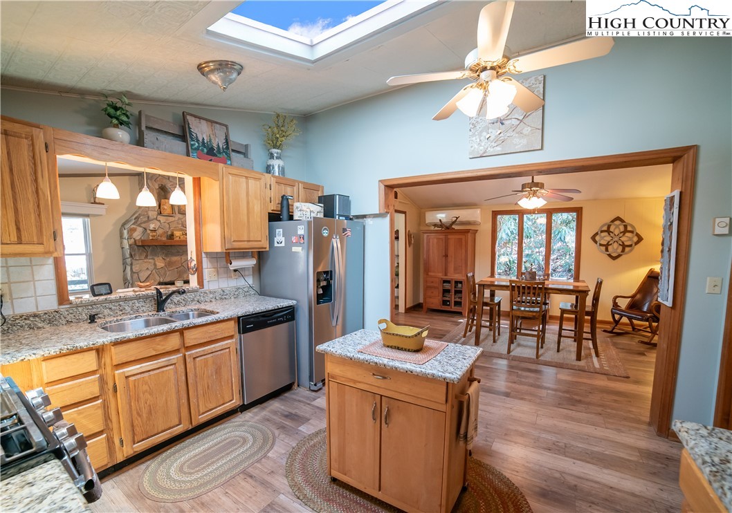 10 Locust Road Newland, NC 28657 - Photo 12 of 36 a kitchen with stainless steel appliances granite countertop a stove and cabinets
