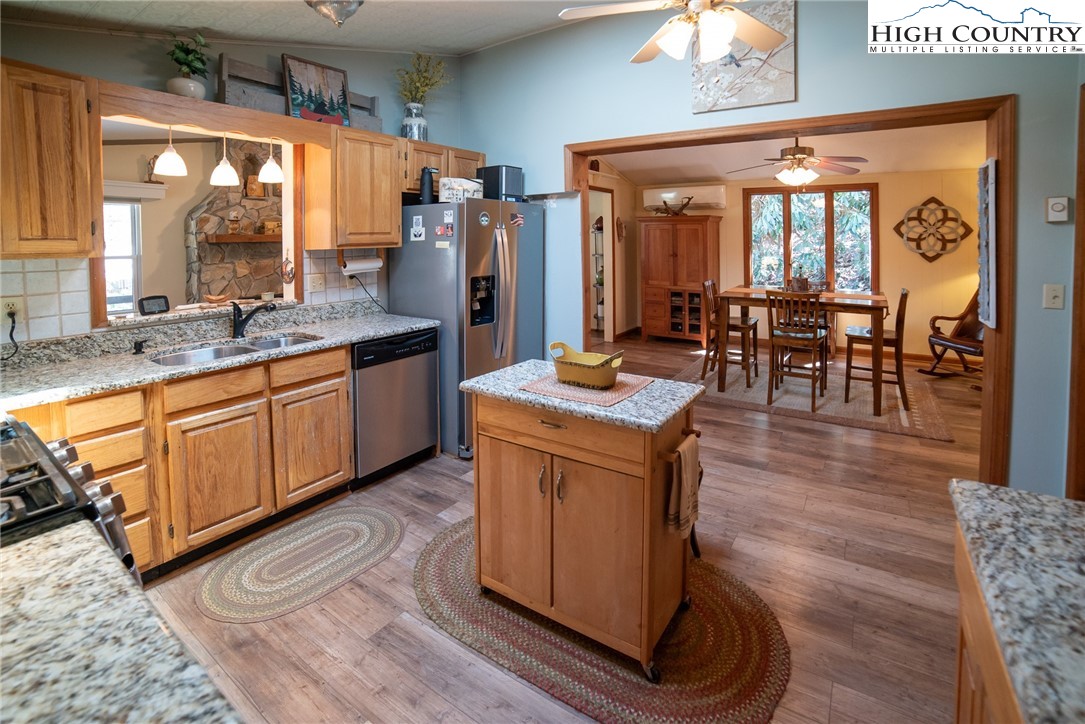 10 Locust Road Newland, NC 28657 - Photo 13 of 36 a kitchen with stainless steel appliances granite countertop wooden floors and sink