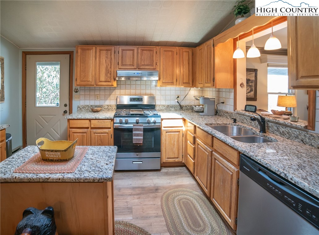 10 Locust Road Newland, NC 28657 - Photo 14 of 36 a kitchen with granite countertop kitchen island a sink a stove and a window
