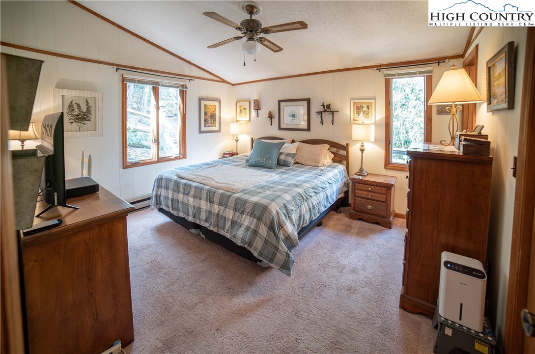 10 Locust Road Newland, NC 28657 - Photo 17 of 36 a bedroom with a bed window and a flat screen tv