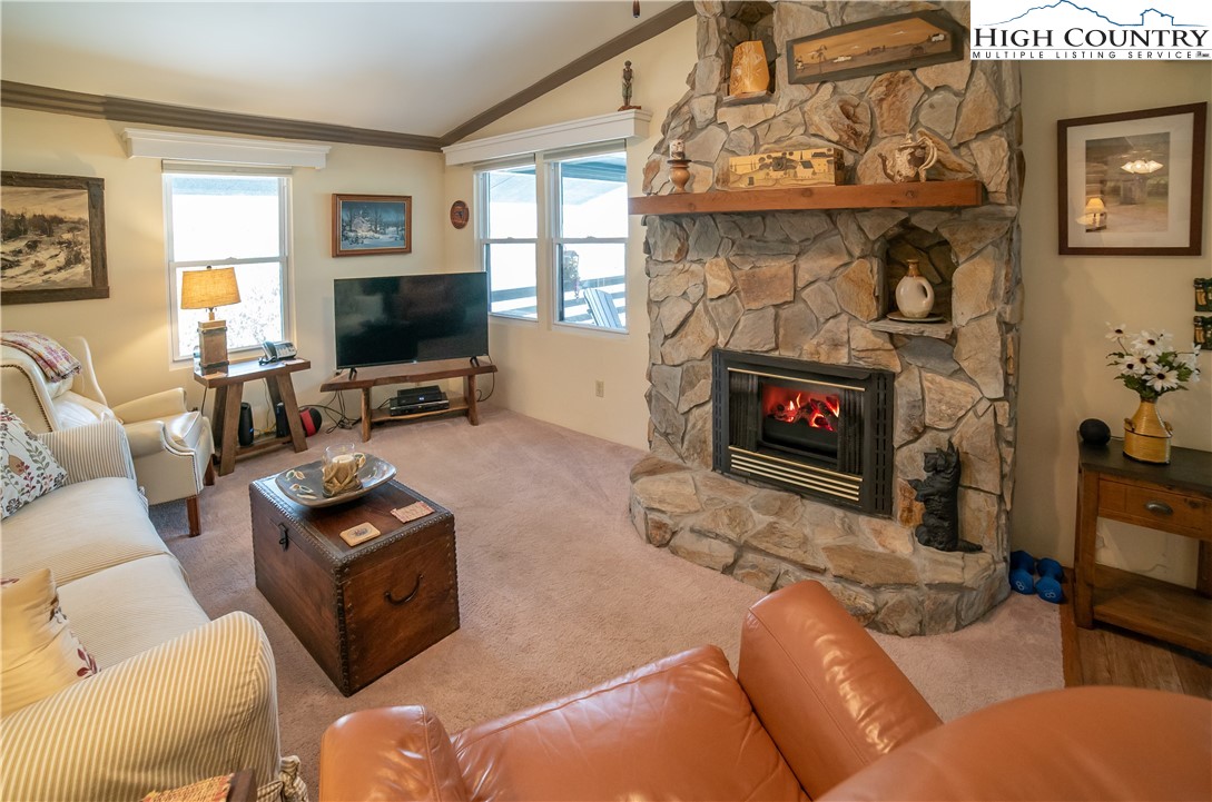 10 Locust Road Newland, NC 28657 - Photo 10 of 36 a living room with furniture a flat screen tv and a fireplace