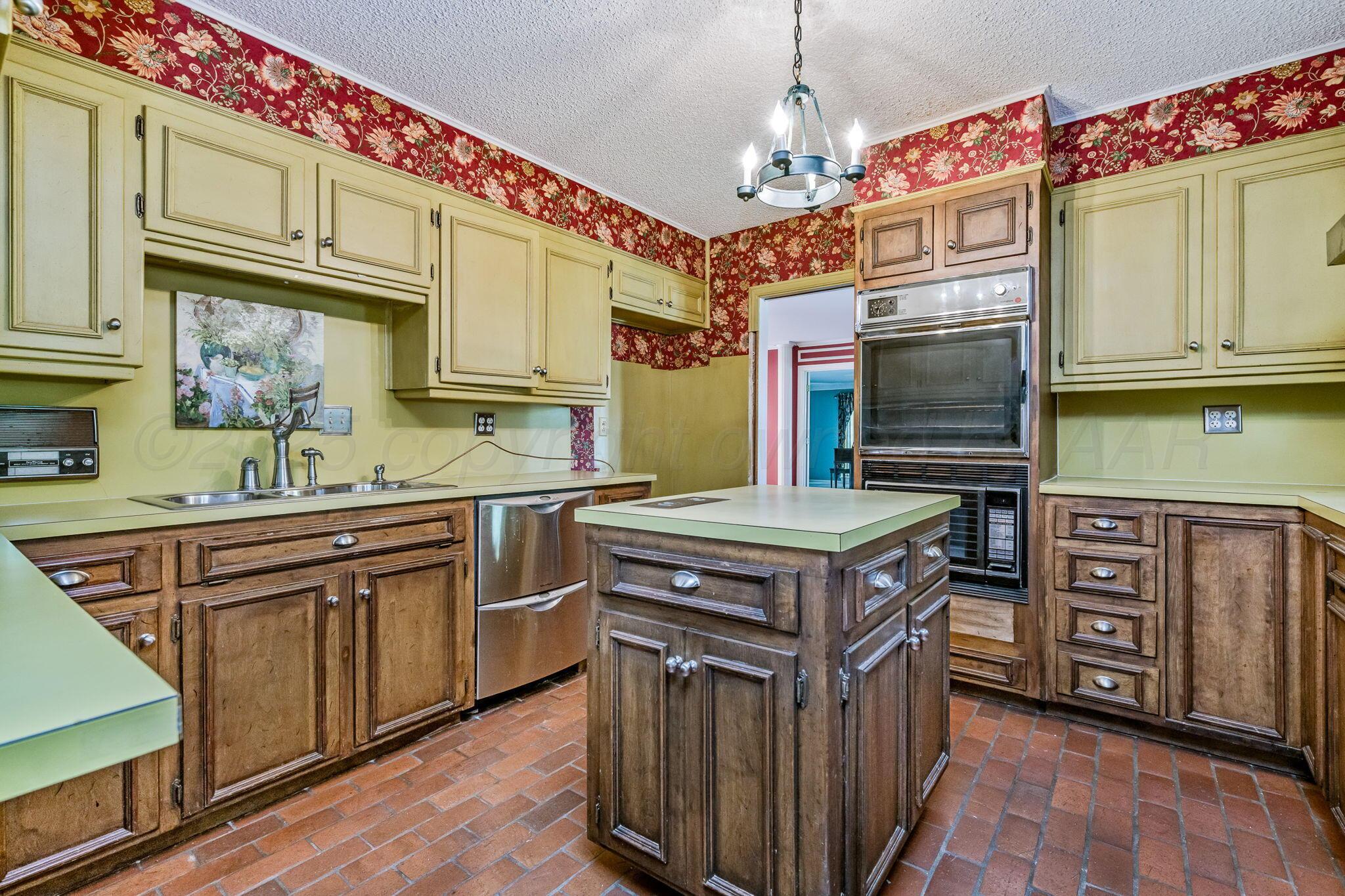 112 Western Street Claude, TX 79019 - Photo 15 of 41 a kitchen with stainless steel appliances granite countertop a stove top oven a sink dishwasher and cabinets with wooden floor