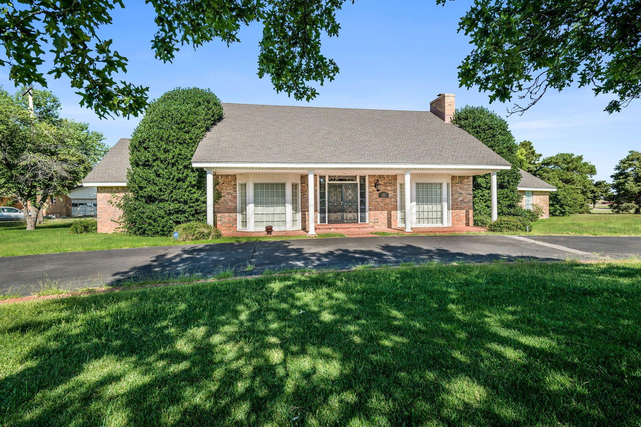112 Western Street Claude, TX 79019 - Photo 2 of 41 a front view of a house with a yard