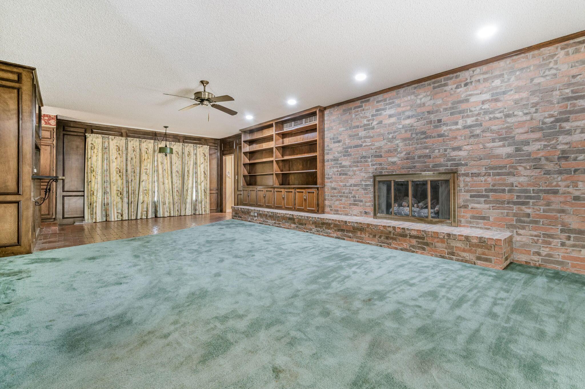112 Western Street Claude, TX 79019 - Photo 22 of 41 a view of an empty room with a fireplace and a window