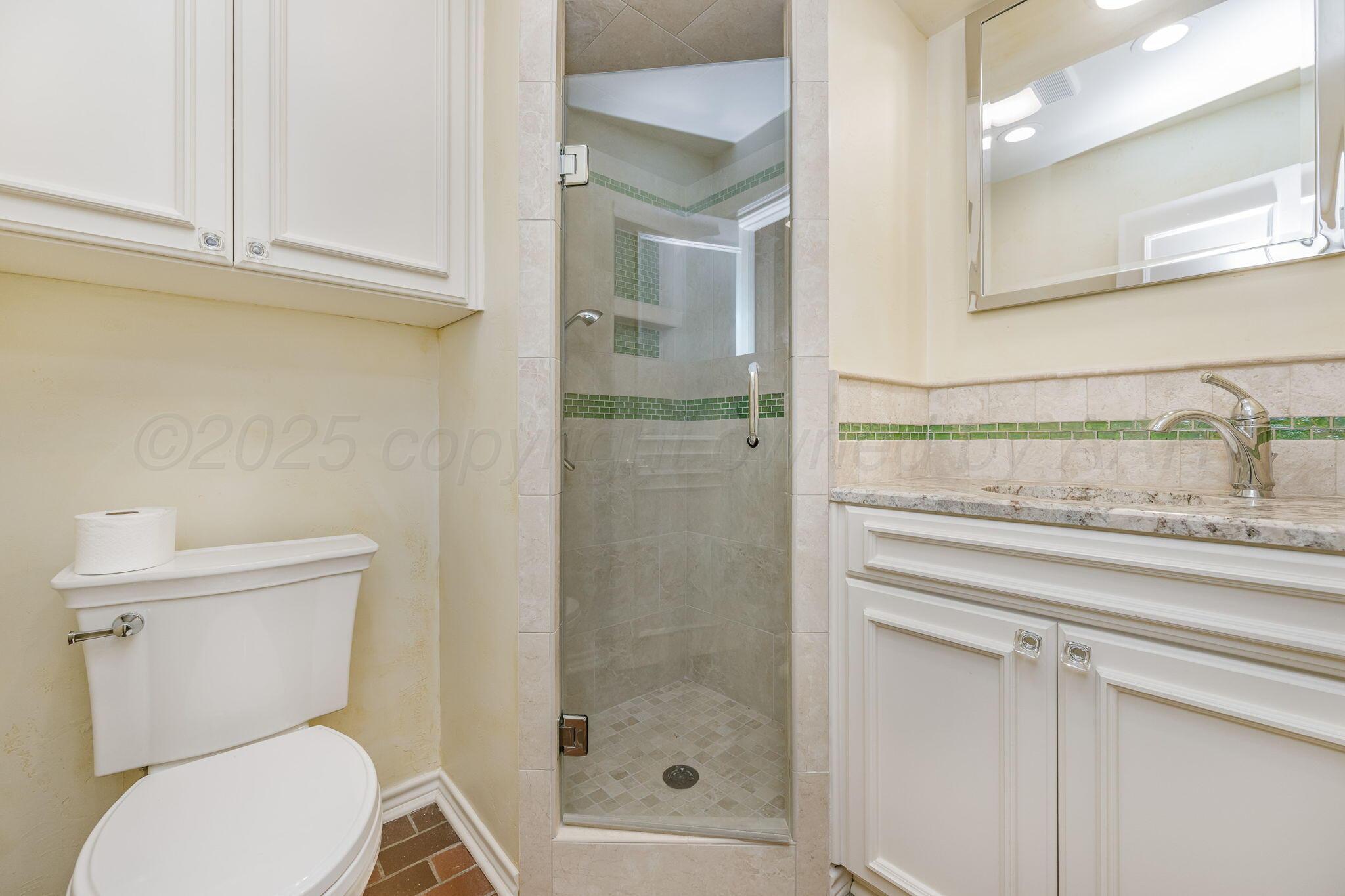 112 Western Street Claude, TX 79019 - Photo 26 of 41 a bathroom with a toilet a sink and shower