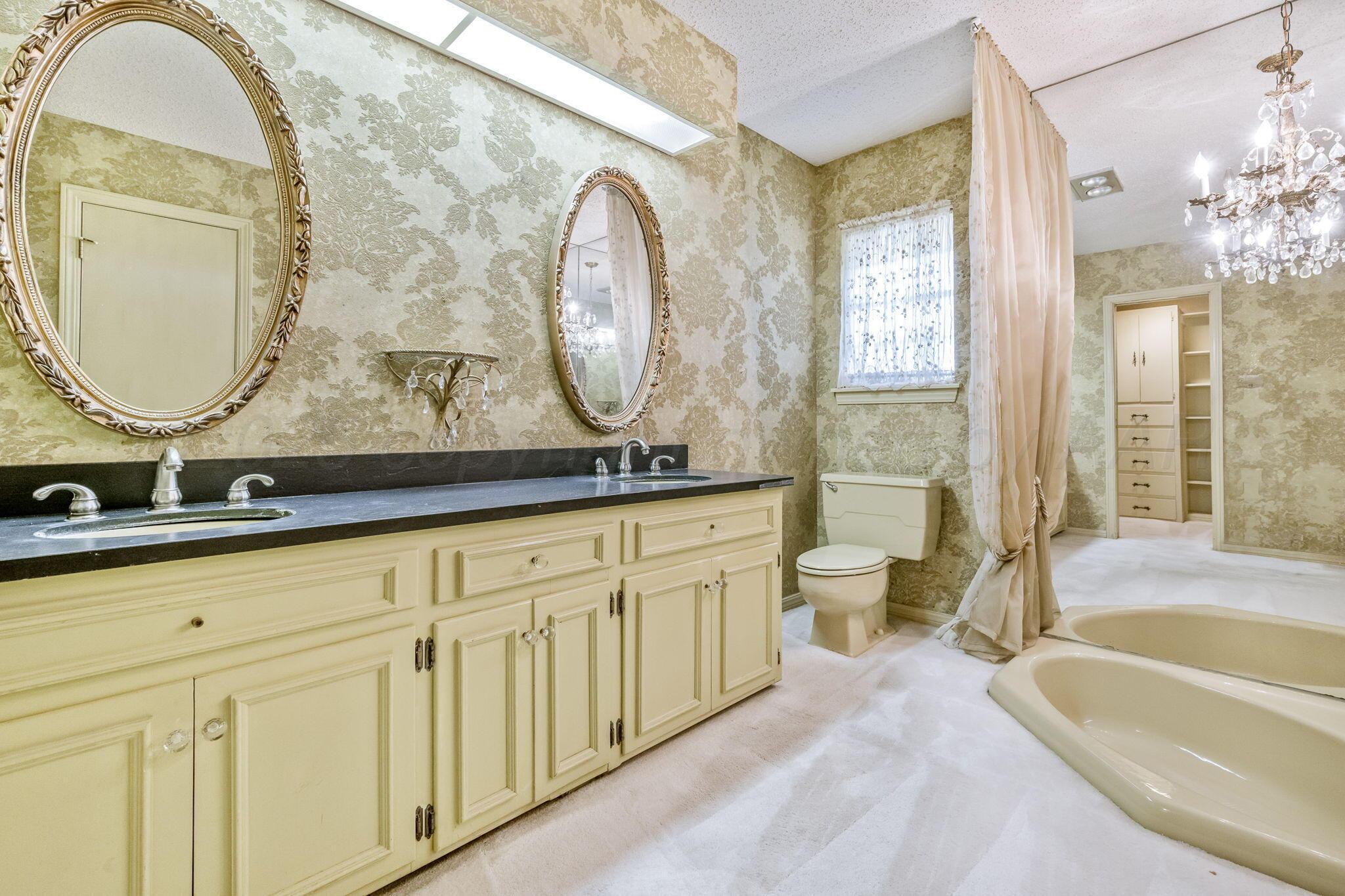 112 Western Street Claude, TX 79019 - Photo 29 of 41 a spacious bathroom with a mirror a sink and a mirror