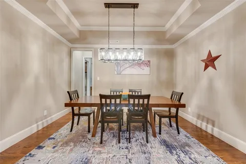 a view of a dining room with furniture and chandelier