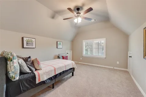 a spacious bedroom with a bed and a chandelier