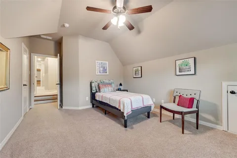 a spacious bedroom with a bed and a chandelier