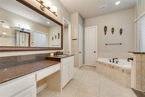 a large white bathroom with a large tub sink and vanity